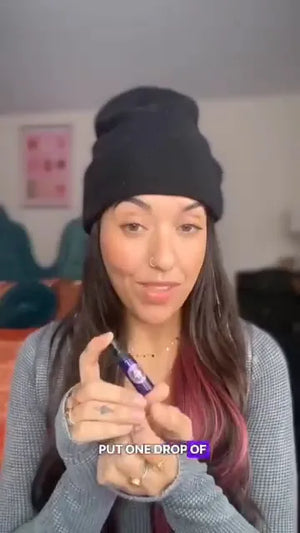 Woman holding a purple item with text overlay in an indoor setting
