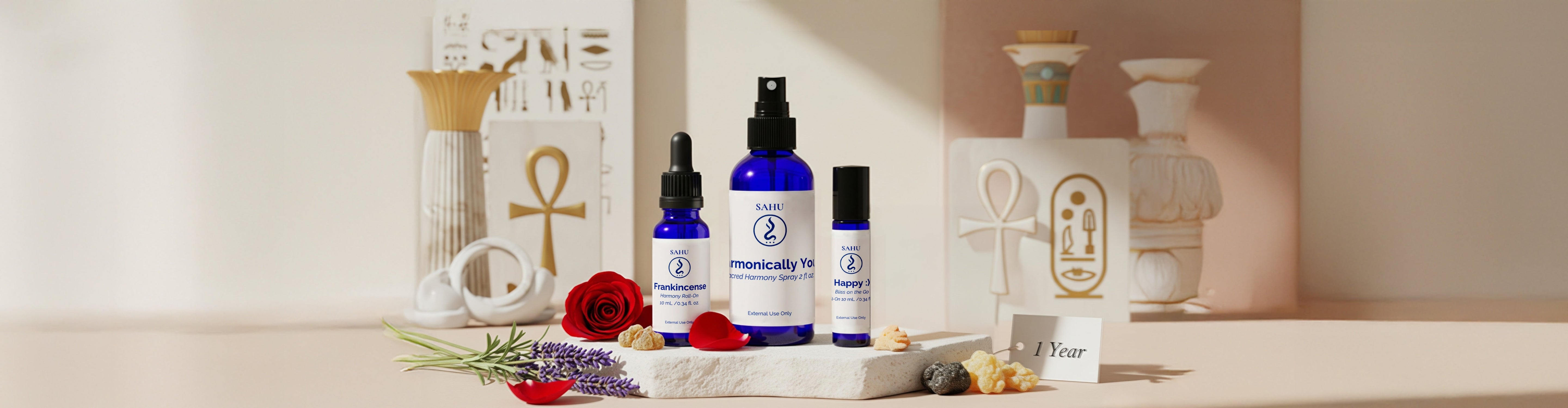 SAHU anniversary display featuring aromatherapy oils with elegant decor and Egyptian symbols.